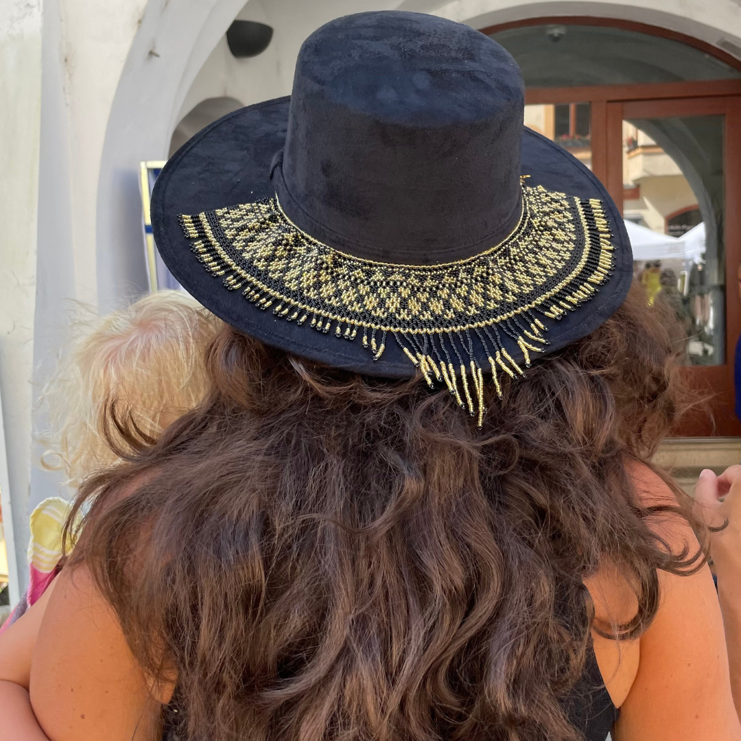 woman holding a baby wearing a Matilda Gira hat with handmade hat accessory